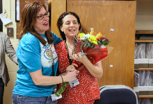 Principal Collison presents Dr. Hettrich with flowers.