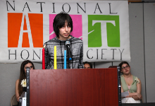 Student speaks at podium during ceremony.