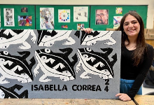 Isabella poses with her artwork.