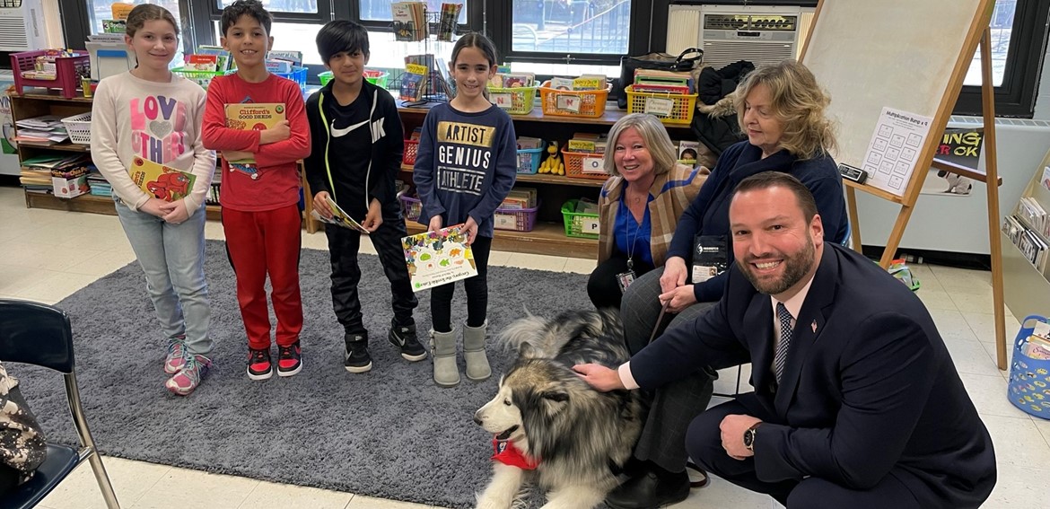 Students just love reading to Sierra from Therapy Dogs International!