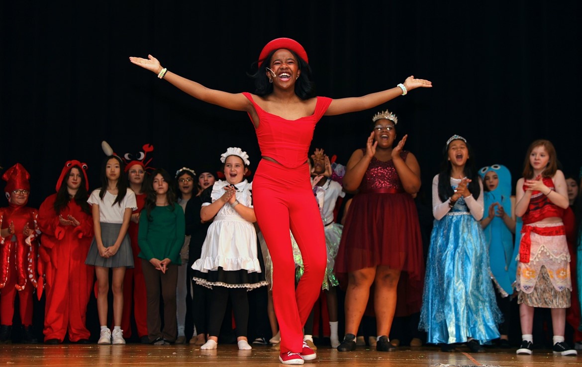 Middle School actress is cheered by crowd at conclusion of The Little Mermaid performance for fifth graders.