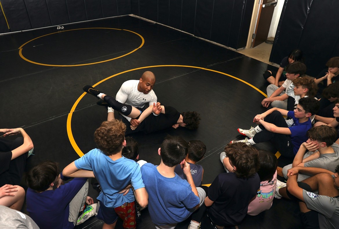 Inspirational wrestler Rohan Murphy provides tips to the middle school wrestling team.