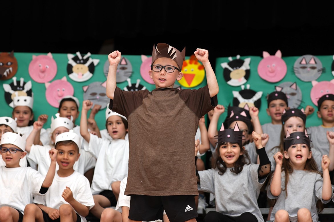 Student dressed as &#34;the big bad wolf&#34; in front of fellow North Ridge kindergarteners on stage during performance.