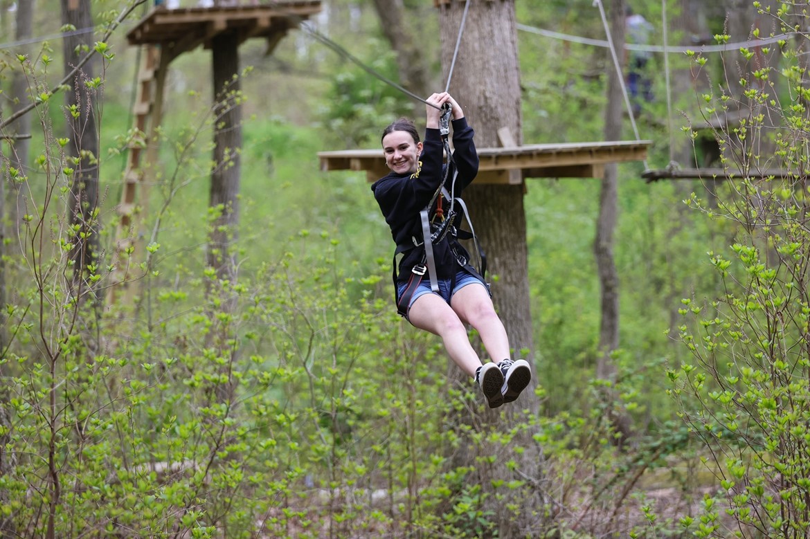 Student uses zip line at The Adventure Park at Long Island.